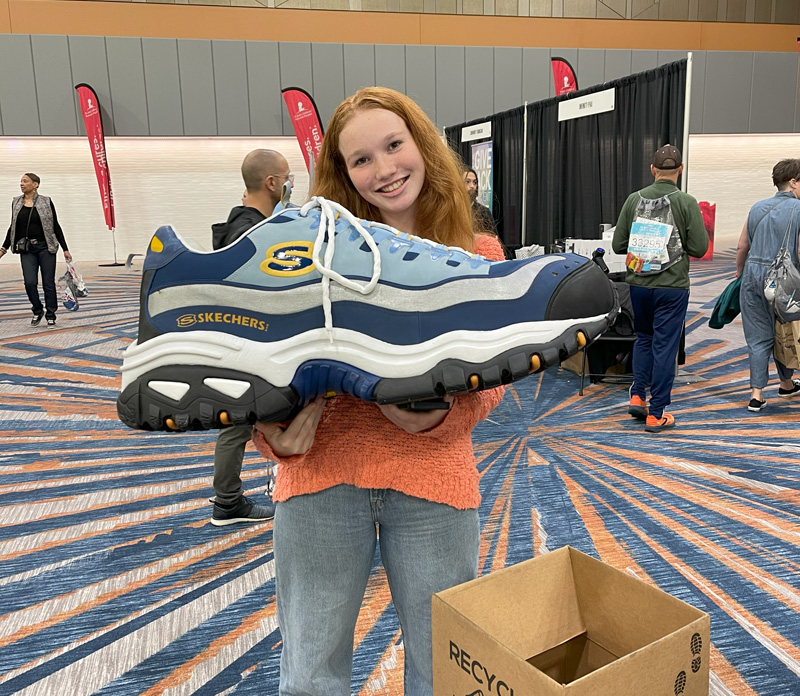 Young woman holding shoe
