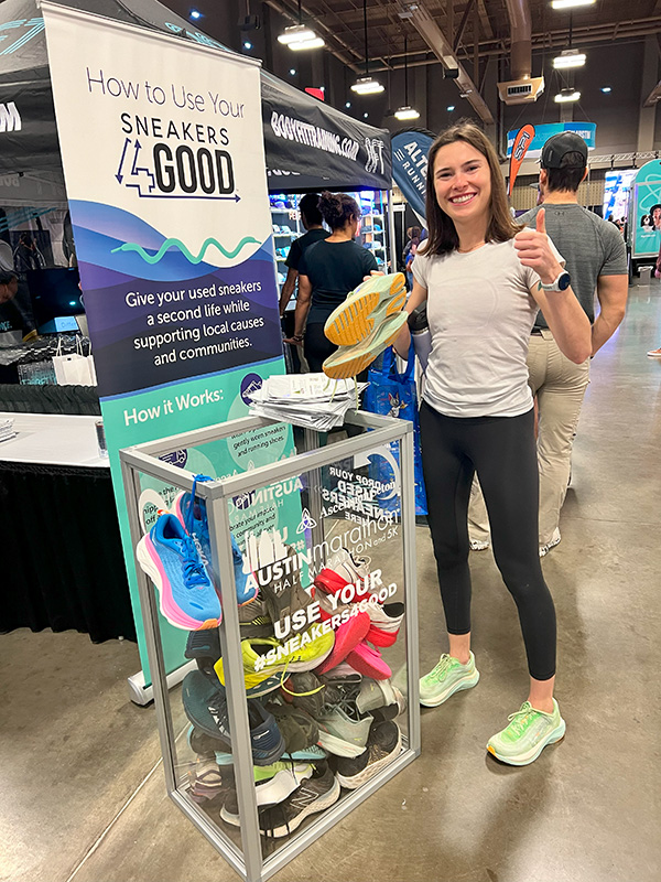 Young woman standing in front of collection box