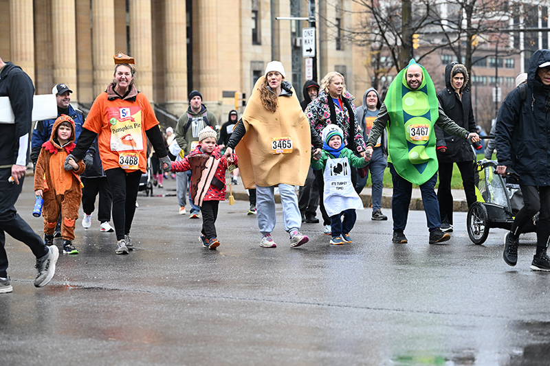 A group of families cross the finish line at the Buffalo Niagara YMCA Turkey Trot.