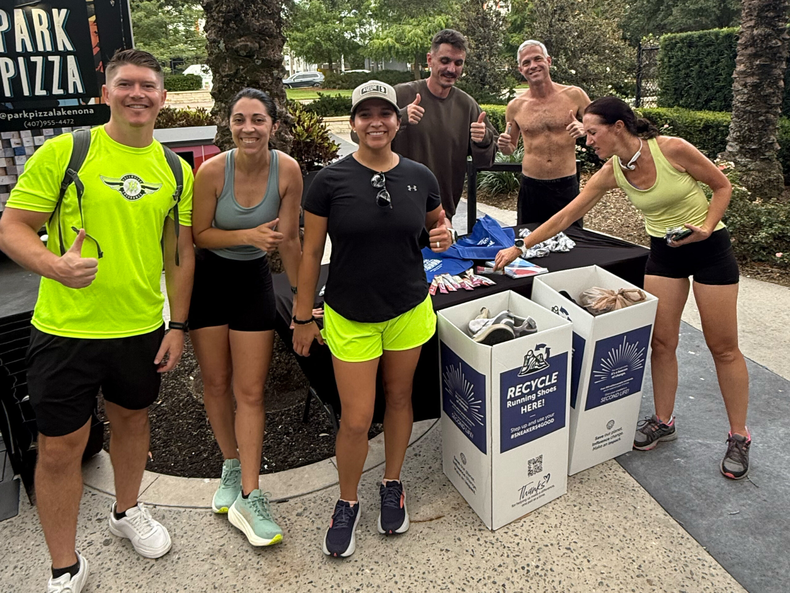Group of runners donating shoes to Sneakers4Good after a run.
