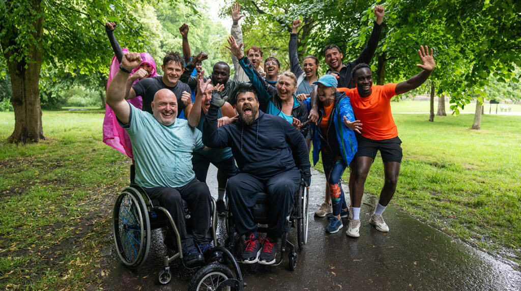 Front view of cheerful race participants who finished an inclusive run for all ages and abilities, representing diversity in sports and community.