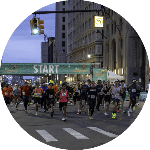 Runners at the S3 Turkey Trot Start Line using their Sneakers4Good.