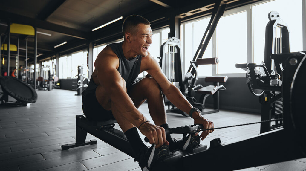 A man on a rowing machine which is excellent cross training for runners.