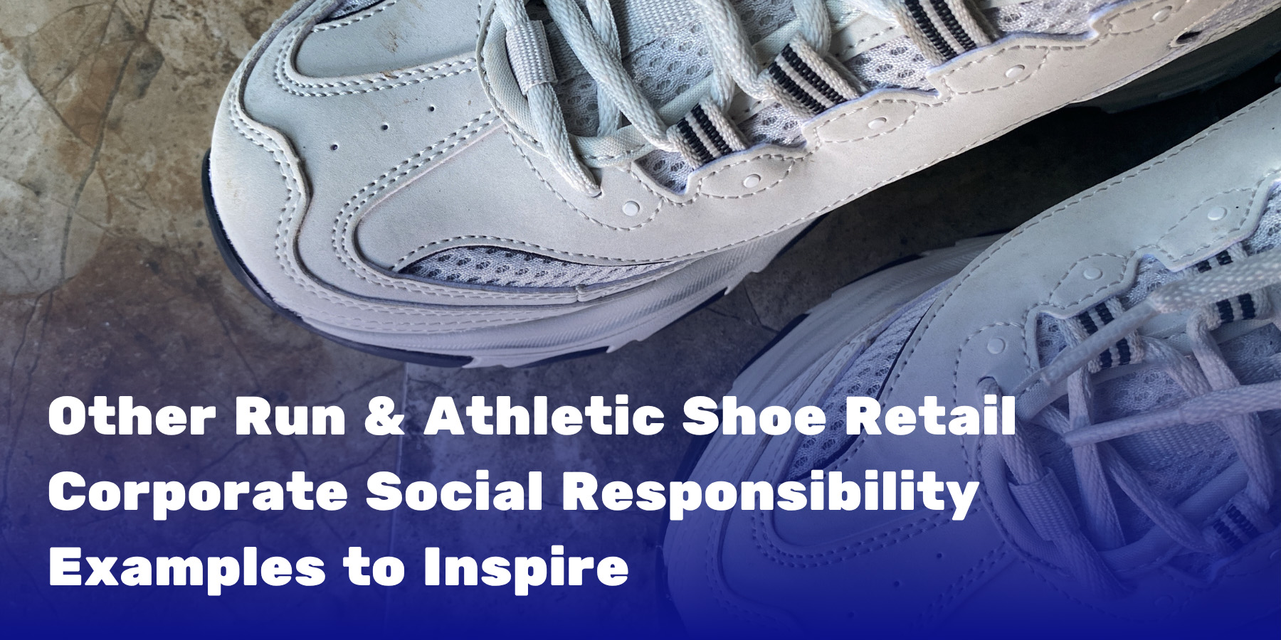 Close-up of two white athletic shoes on a tile floor, representing sneakers collected through a retail sustainability initiative.